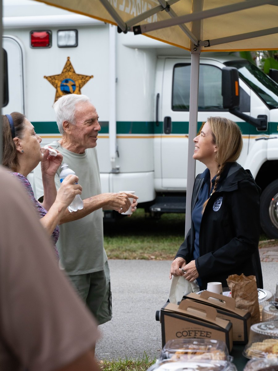 Commissioner Raquel Regalado serving coffee to residents at a community event